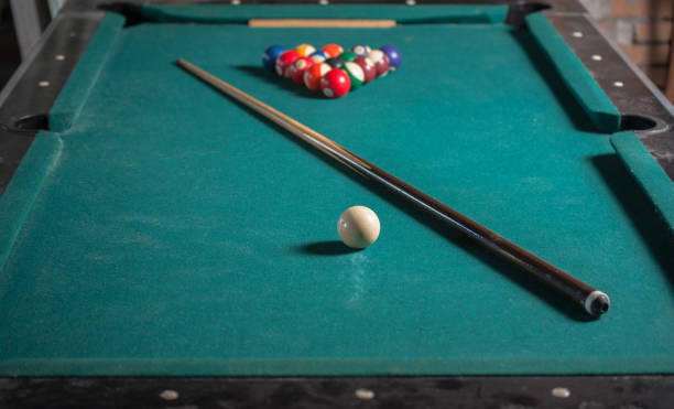 istock Billiards balls and cue on billiards table. Billiard sport concept 1168385684