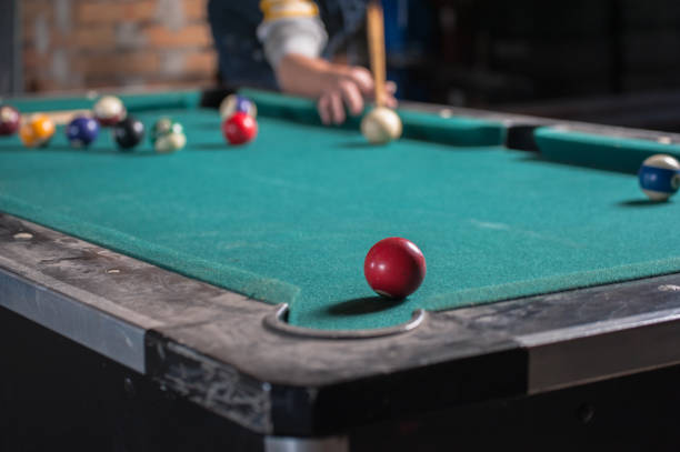 istock Billiards balls and cue on billiards table. Billiard sport concept 1168385758