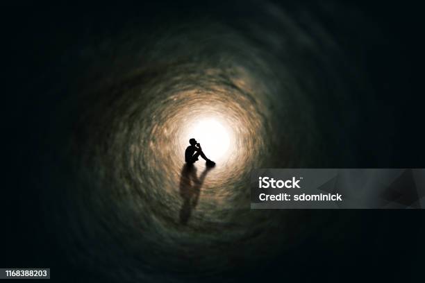 Teen Boy Silhouette Far Away Praying In Tunnel Stock Photo - Download Image Now - Depression - Sadness, Mental Health, Child