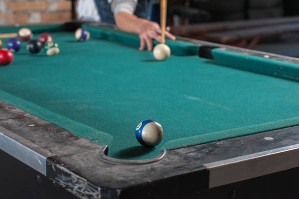 istock Billiards balls and cue on billiards table. Billiard sport concept 1168388341
