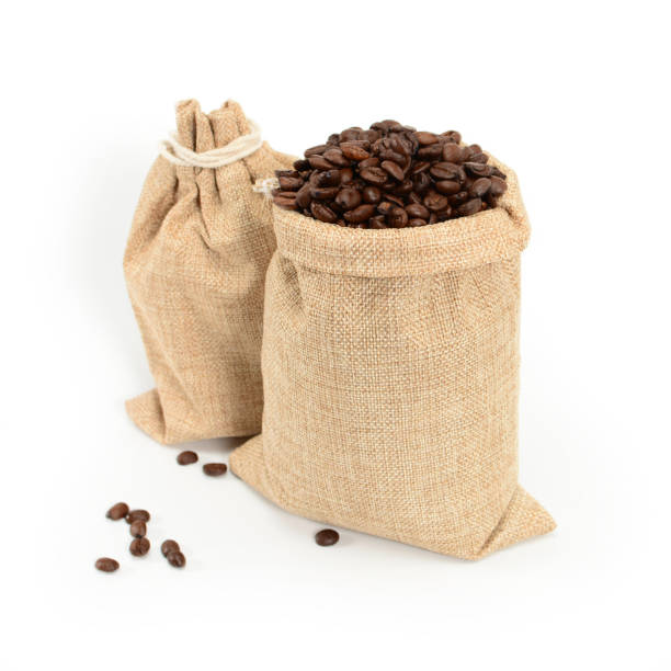 istock Coffee beans. Two jute burlap sacks with hard roasted coffee beans, isolated on white background. 1168390481