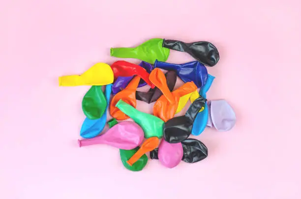 Photo of Many multicolored deflated balloons.