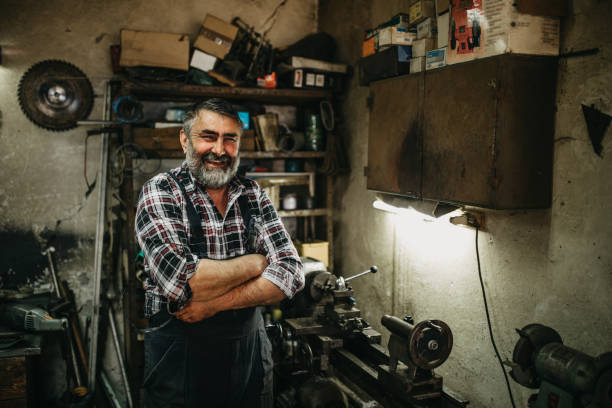 istock Senior man cutting metal in workshop 1168395177
