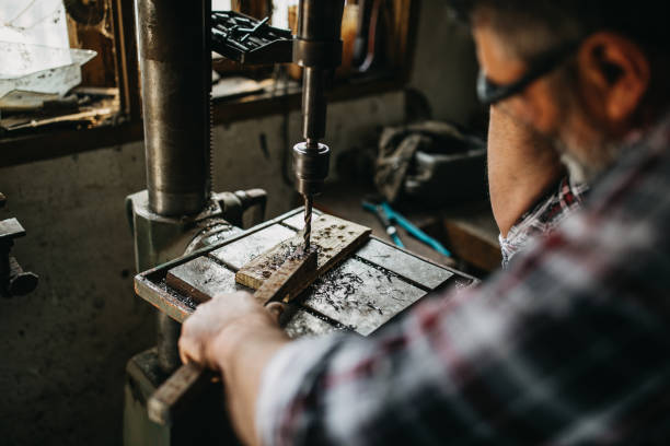 istock Senior man cutting metal in workshop 1168395219