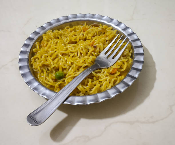 istock cooked instant noodles in plate with fork 1168396652