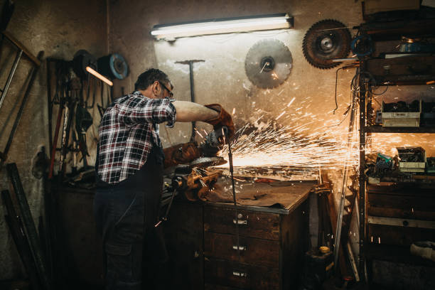 istock Senior man cutting metal in workshop 1168397561