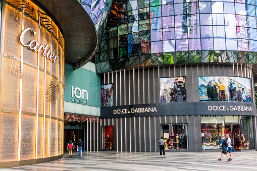 Singapore City - People outside luxury stores Dolce & Gabbana and Cartier on Orchard Road, one of Singapore's most popular shopping streets.