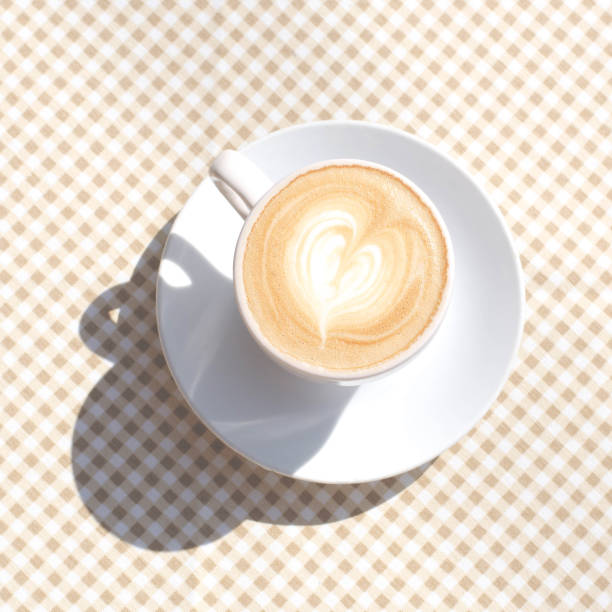 istock A cup of coffee on the table with a checkered tablecloth. 1168399770