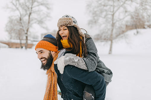 A young couple enjoys the first snow