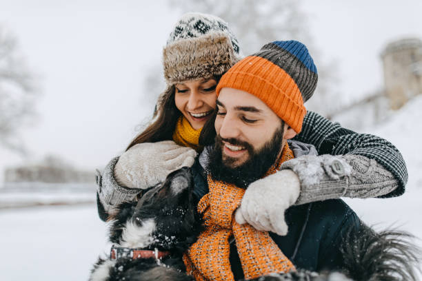 istock Happy young couple having fun in snow 1168401616