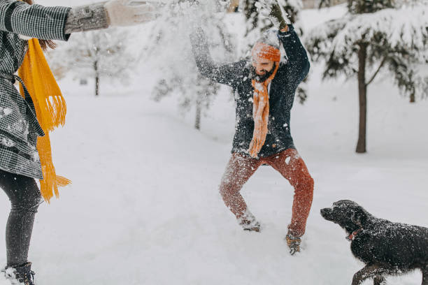 istock Happy young couple having fun in snow 1168401861
