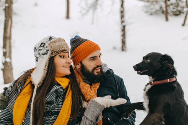 istock Happy young couple having fun in snow 1168402853