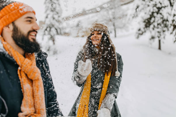 istock Happy young couple having fun in snow 1168403219