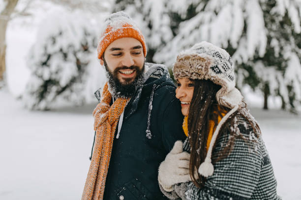 istock Happy young couple having fun in snow 1168404922