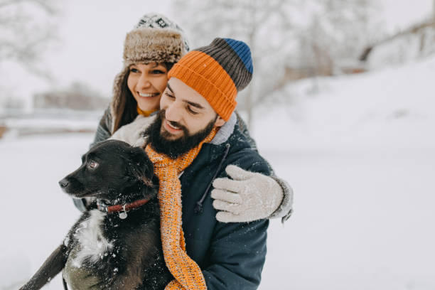 istock Happy young couple having fun in snow 1168404924