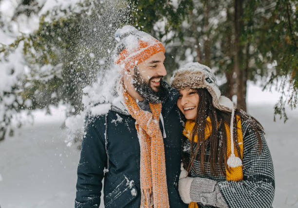 istock Happy young couple having fun in snow 1168405000