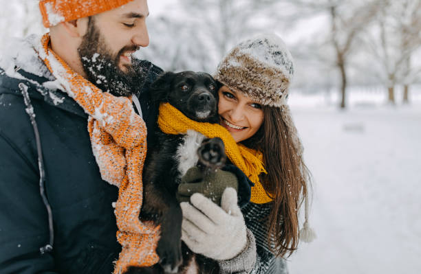 istock Happy young couple having fun in snow 1168405071