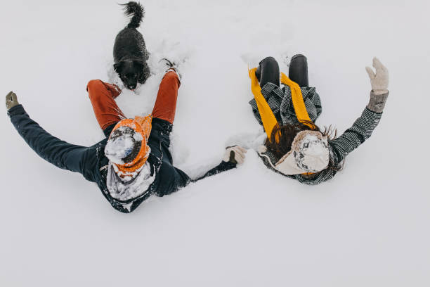istock Happy young couple having fun in snow 1168405134