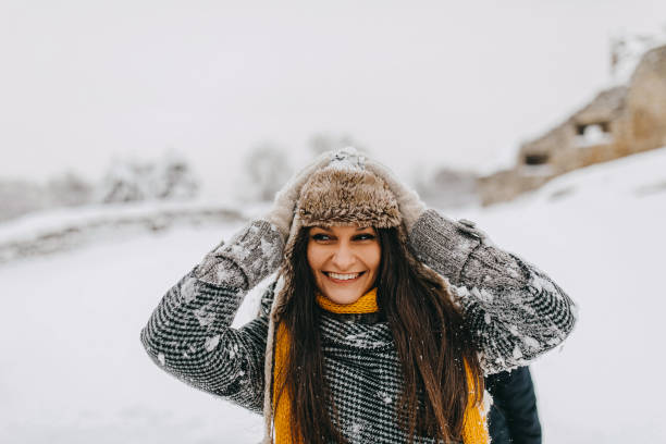 istock Young woman having fun in snow 1168405135