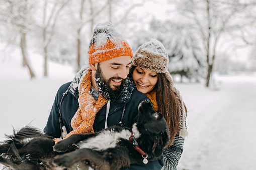 Happy young couple having fun in snow