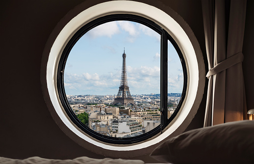 Looking through window, Eiffel tower famous landmark in Paris, France. Vacation in Europe