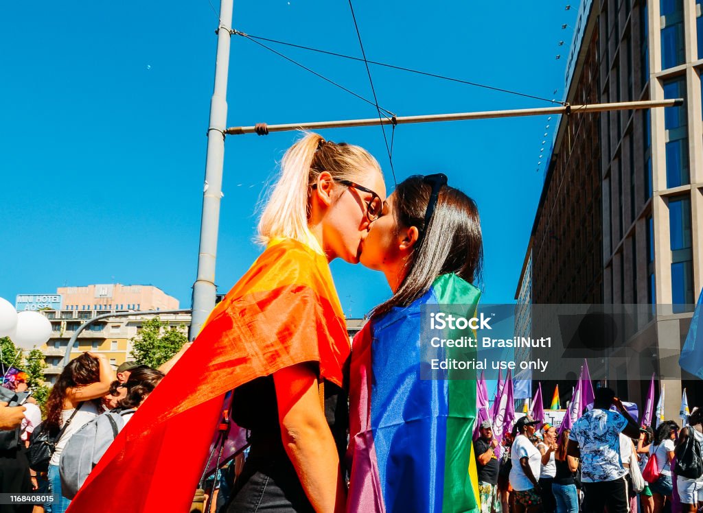 Women kissing at gay pride marching claiming for equality and legal rights for the LGBTQI community Milan, Italy - June 29, 2018: Women kissing at gay pride marching claiming for equality and legal rights for the LGBTQI community Milan Stock Photo