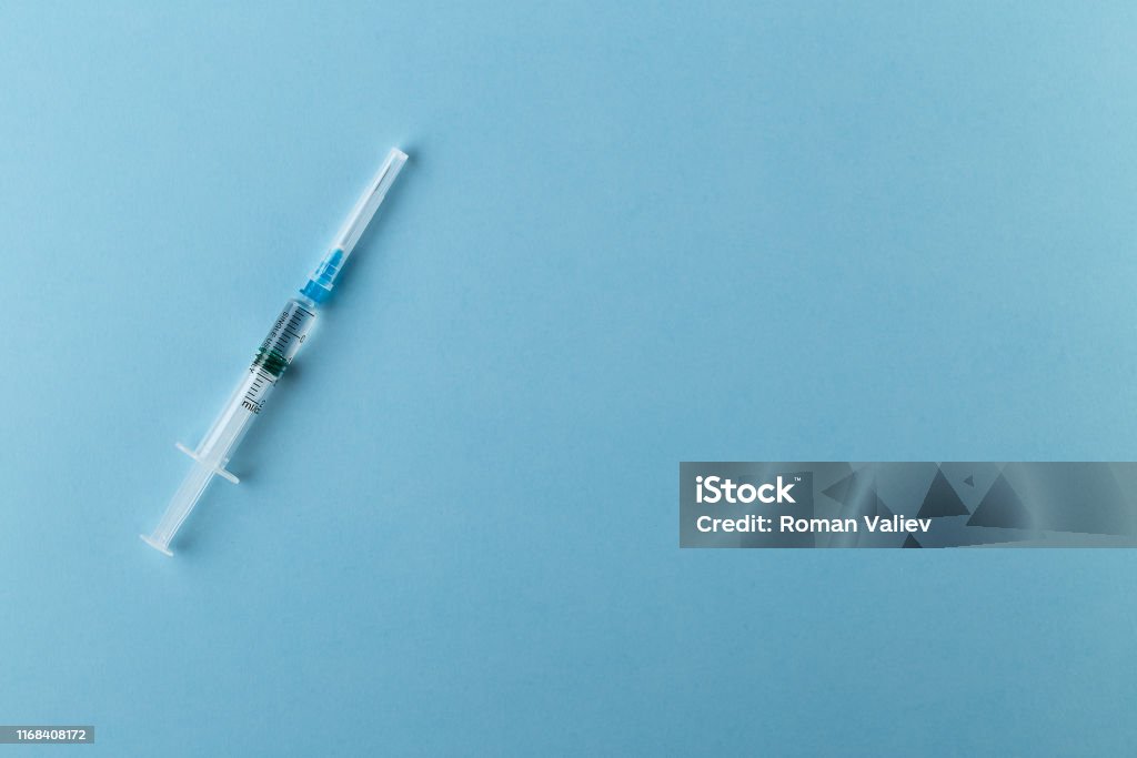 Syringe on blue background Syringe, vaccine, isolated, blue Vaccination Stock Photo