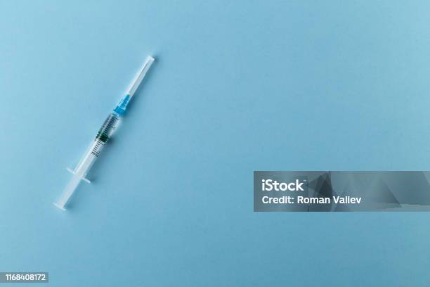 Syringe On Blue Background Stock Photo - Download Image Now - Vaccination, Syringe, Injecting
