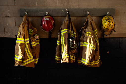 firefighter protection clothe and respiratory mask hanging on the fire station wall