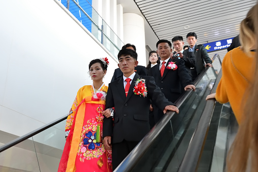Pyongyang, North Korea - April 29, 2019: Korean newlyweds couple in Pyongyang International Airport