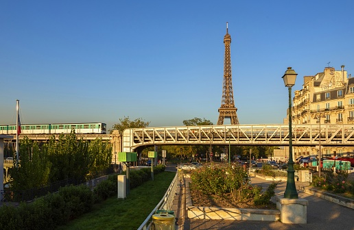 Paris, France, October 3, 2015: A metro line goes over the Pont de Bir-Hakeim. In the background the Eiffel Tower, an iconic landmark of the French capital.