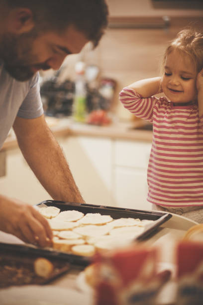 istock Father and his little daughter preparing dinner together 1168412209
