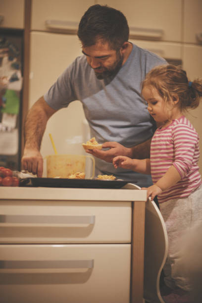 istock Father and his little helper preparing food together 1168413820