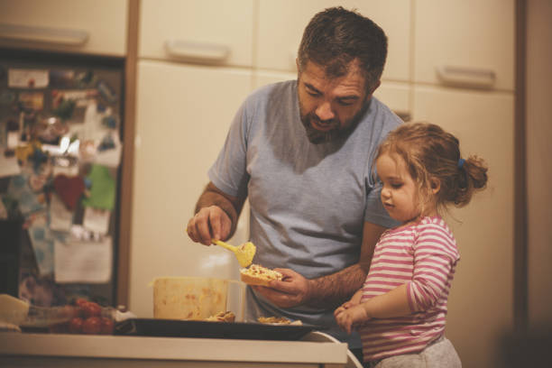 istock Father and his little daughter bonding while preparing food together 1168413907