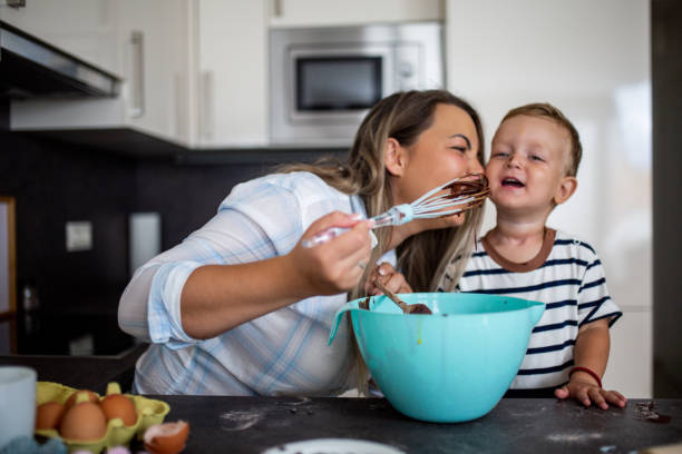 istock Young pretty mother bakes biscuits with her young son 1168413968
