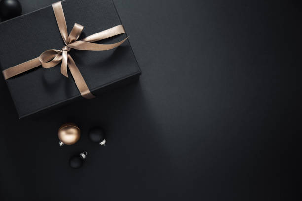 istock Gift wrapped in dark paper on dark background 1168414767