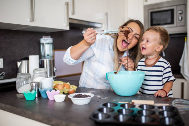 istock Young pretty mother bakes biscuits with her young son 1168414803