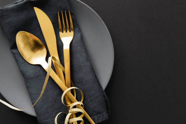 istock Gold cutlery served on plate for Christmas Dinner 1168415173