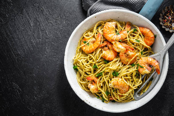 istock Spaghetti pasta with pesto and shrimps 1168415259