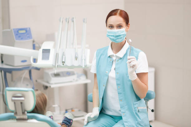 istock Red-haired child dentist wearing uniform and mask 1168420677