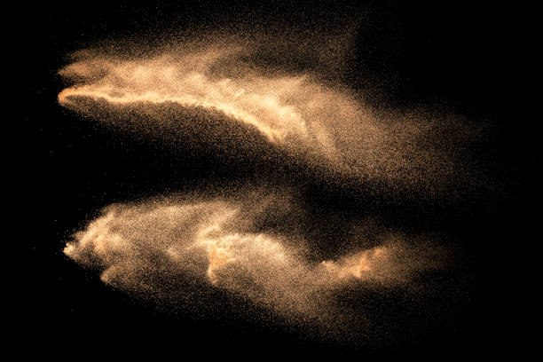 istock Brown colored sand splash against dark background. Dry river sand explosion isolated on black background. Abstract sand cloud. 1168425703