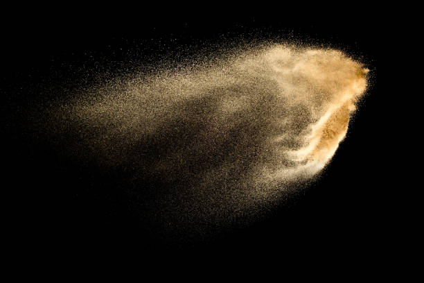 istock Brown colored sand splash against dark background. Dry river sand explosion isolated on black background. Abstract sand cloud. 1168425718