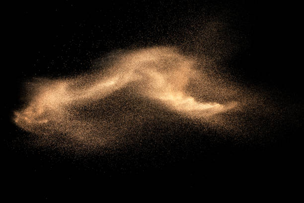 istock Brown colored sand splash against dark background. Dry river sand explosion isolated on black background. Abstract sand cloud. 1168425732