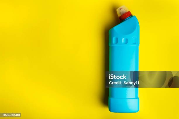 Detergent Bottle On Bright Yellow Background Stock Photo - Download Image Now - Bathroom, Blue, Bottle