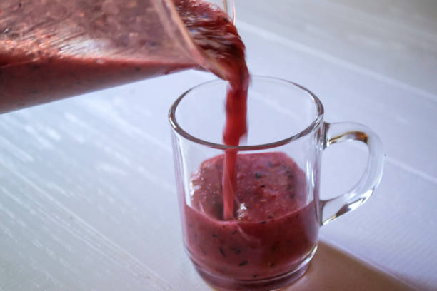 istock Pouring fruit smoothie in the glass cup. 1168430614