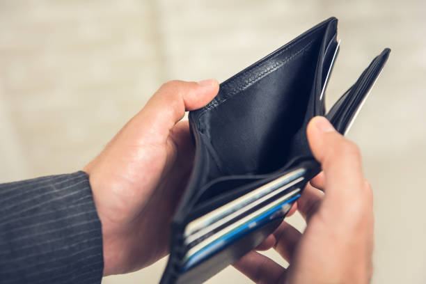 istock Man hands showing empty wallet with no money 1168430886