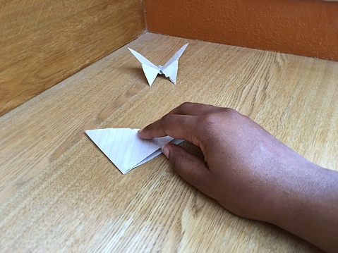 A hand doing origami