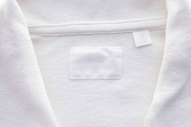 istock Blank white clothes label on new shirt background 1168435477
