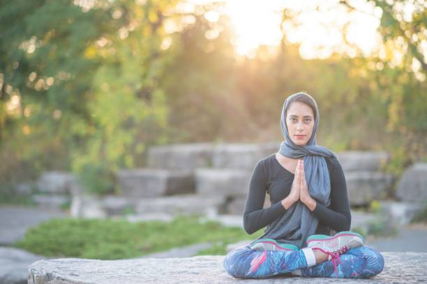 istock Muslim woman doing yoga 1168439603