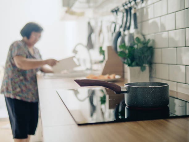 istock Senior woman making egg boiling in morning at home. 1168440569